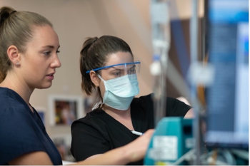 Nurses working with equipment